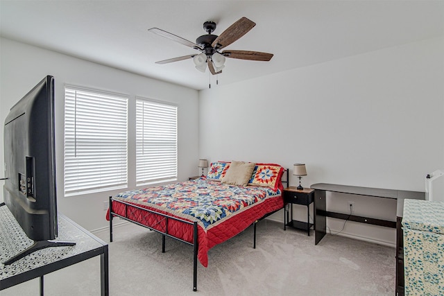 bedroom with ceiling fan and light colored carpet