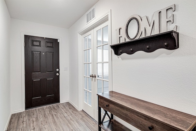 entryway featuring french doors and light hardwood / wood-style flooring