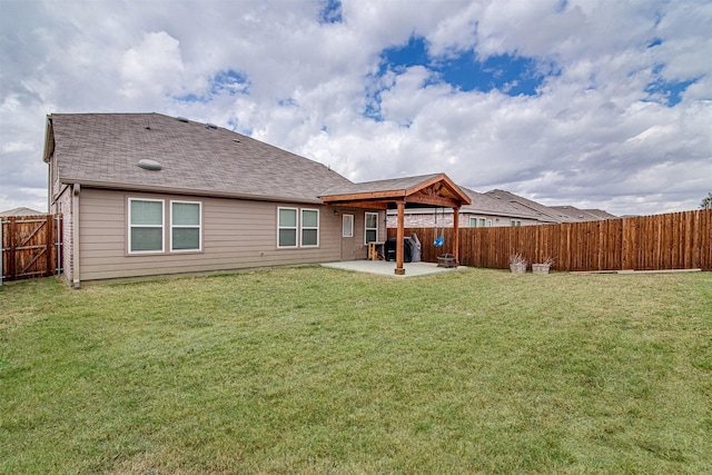 rear view of property featuring a yard and a patio