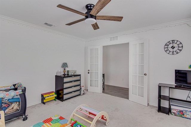 game room with french doors, light colored carpet, ceiling fan, and ornamental molding