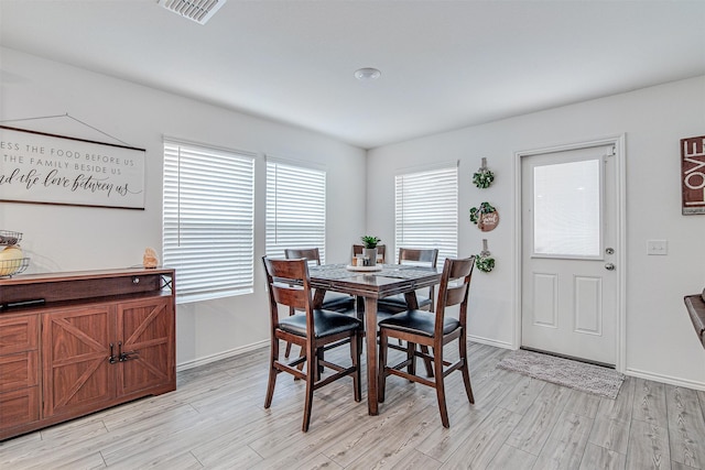 dining space with light hardwood / wood-style floors