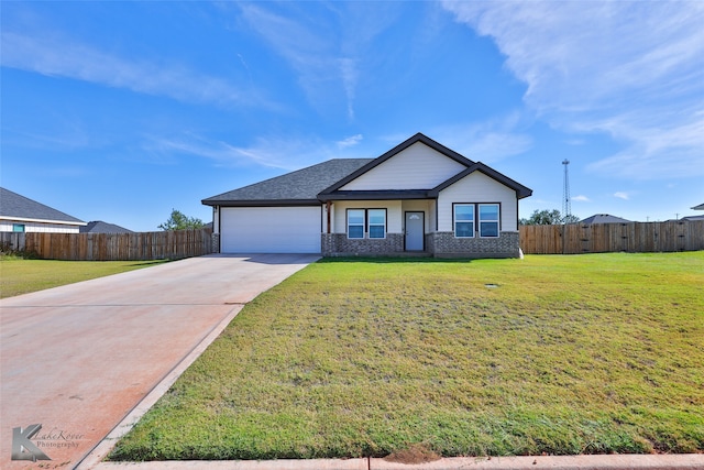 view of front of home featuring a garage and a front yard