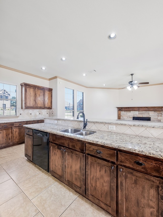 kitchen with a healthy amount of sunlight, sink, dishwasher, and tasteful backsplash