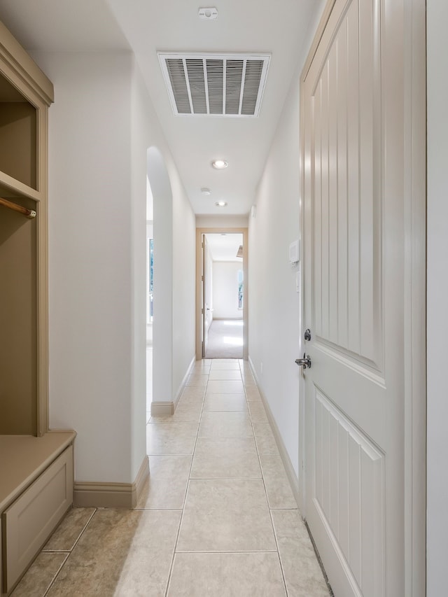 hall featuring light tile patterned floors