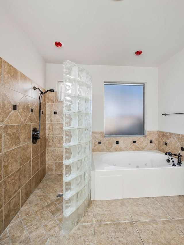 bathroom featuring tile patterned floors and independent shower and bath