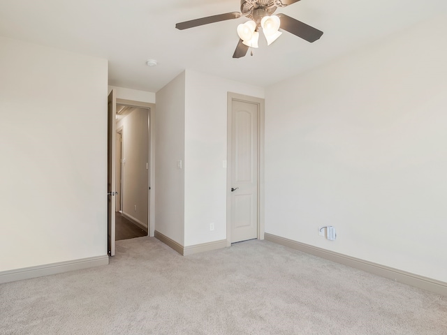 unfurnished bedroom with light colored carpet and ceiling fan