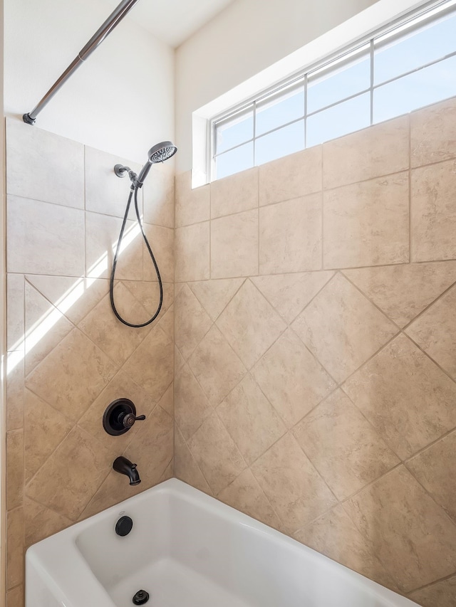 bathroom featuring tiled shower / bath