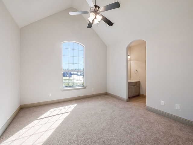 unfurnished room with lofted ceiling, light colored carpet, and ceiling fan