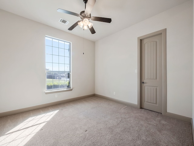 empty room featuring light carpet and ceiling fan