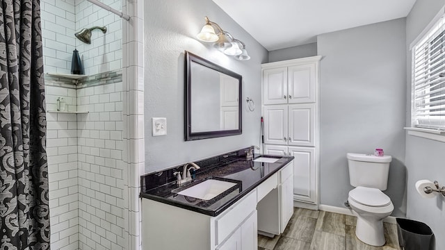 bathroom featuring a shower with shower curtain, wood-type flooring, vanity, and toilet