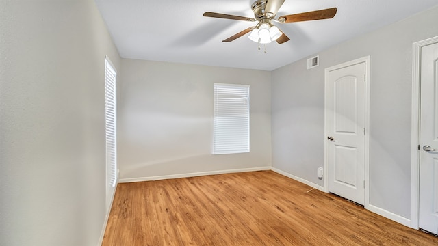 empty room with light wood-type flooring and ceiling fan