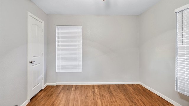 unfurnished room featuring hardwood / wood-style flooring