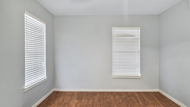 spare room featuring dark wood-type flooring