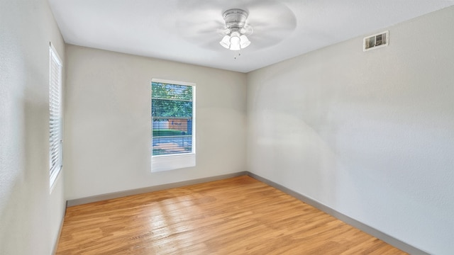 unfurnished room with ceiling fan and light wood-type flooring