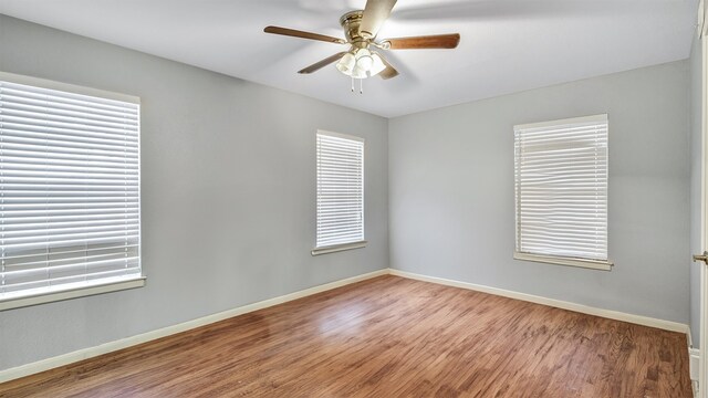 empty room featuring hardwood / wood-style floors and ceiling fan