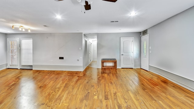 empty room featuring light wood-type flooring and ceiling fan