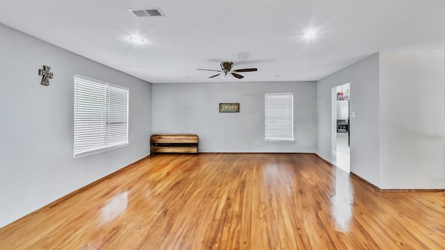 empty room featuring ceiling fan and light hardwood / wood-style floors