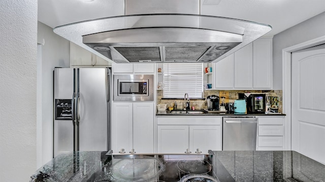 kitchen with island range hood, tasteful backsplash, stainless steel appliances, sink, and white cabinets