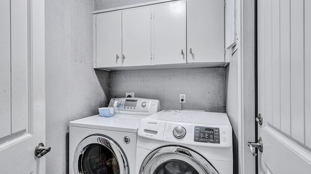 laundry room featuring cabinets and independent washer and dryer