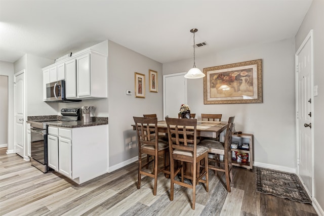 dining room with light hardwood / wood-style flooring