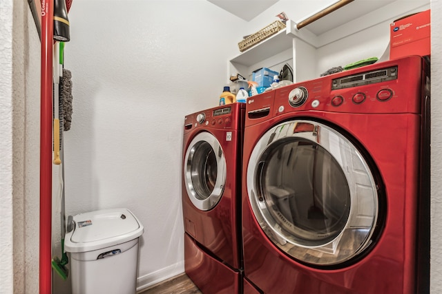 laundry room featuring dark hardwood / wood-style flooring and washing machine and dryer