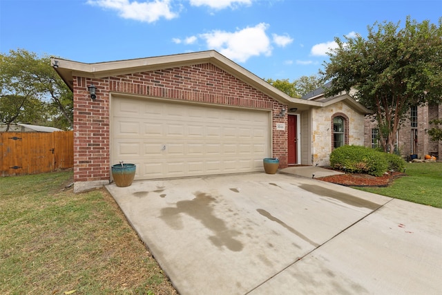 ranch-style house featuring a garage and a front lawn