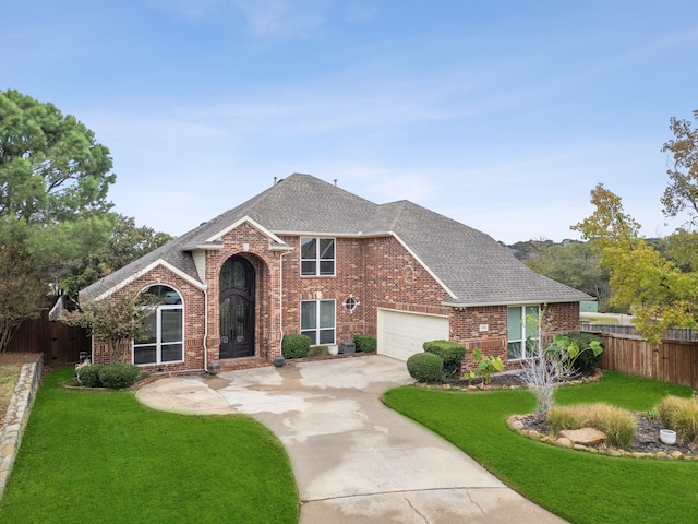 view of front of home featuring a garage and a front yard