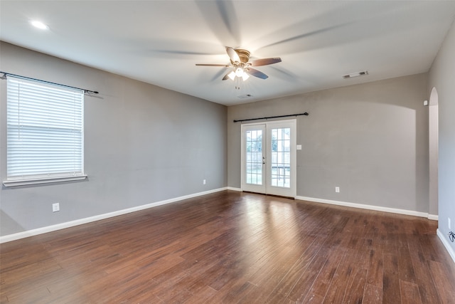 spare room with ceiling fan, dark hardwood / wood-style floors, and french doors