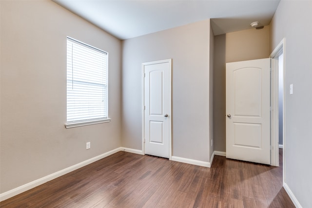 unfurnished bedroom featuring dark wood-type flooring