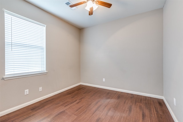 unfurnished room with dark hardwood / wood-style flooring and ceiling fan