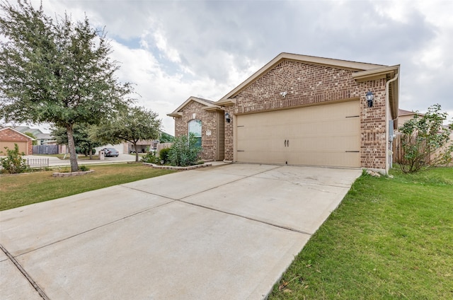 view of front of house featuring a garage and a front lawn