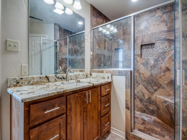 bathroom featuring vanity and an enclosed shower