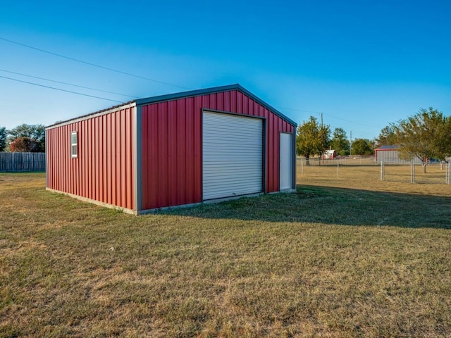 view of outbuilding featuring a garage and a lawn