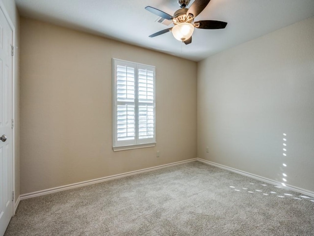 spare room with ceiling fan and carpet flooring