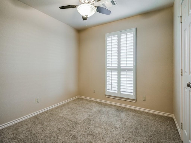 carpeted spare room featuring ceiling fan