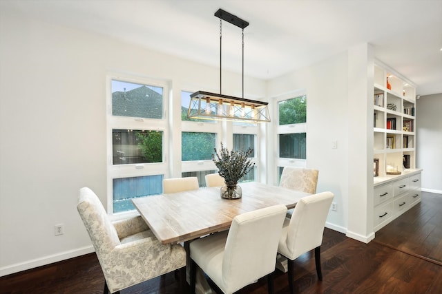 dining room with dark hardwood / wood-style floors and a chandelier