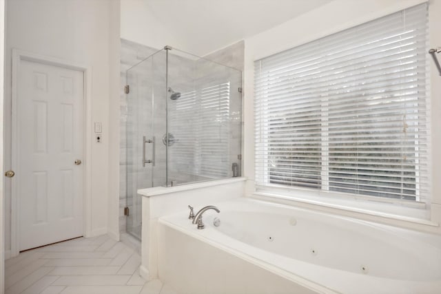 bathroom with tile patterned flooring, a healthy amount of sunlight, and plus walk in shower