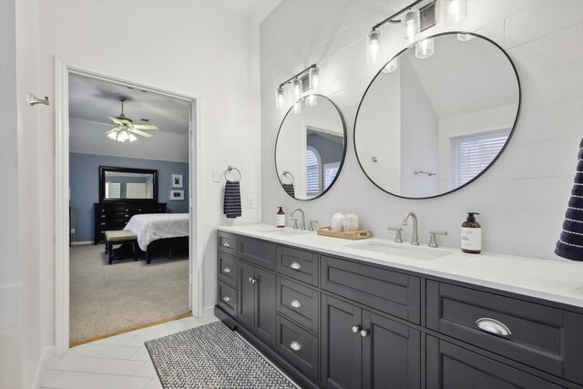 bathroom featuring vanity, vaulted ceiling, tile patterned floors, and ceiling fan