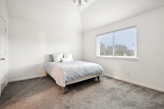 carpeted bedroom with lofted ceiling