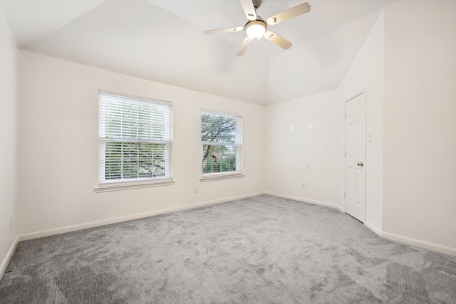 empty room with carpet, ceiling fan, and vaulted ceiling