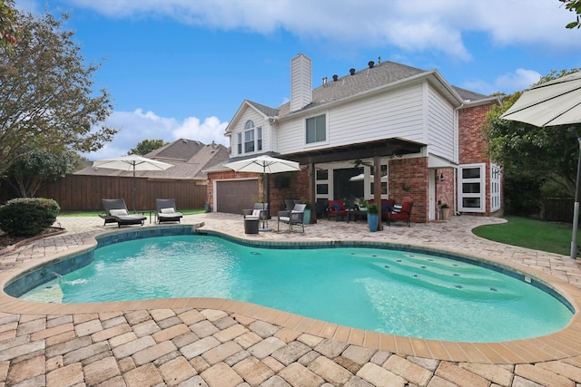 view of swimming pool with ceiling fan and a patio area