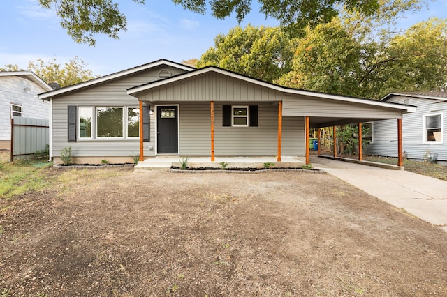 view of front of house featuring a porch and a carport