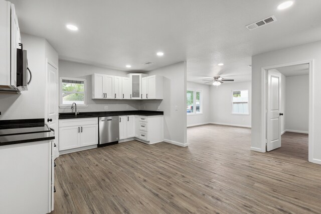 kitchen featuring hardwood / wood-style floors, ceiling fan, white cabinetry, and appliances with stainless steel finishes