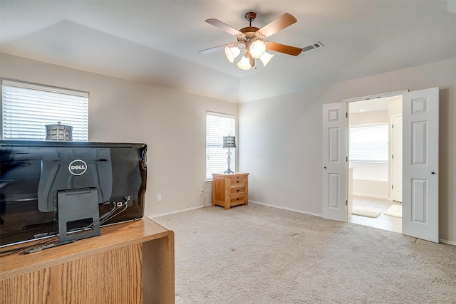 office space with light carpet, ceiling fan, and plenty of natural light