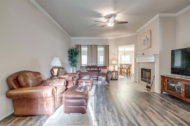 living room with hardwood / wood-style floors, ceiling fan with notable chandelier, and ornamental molding