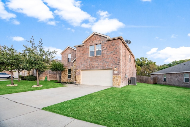 view of property with a garage, central air condition unit, and a front yard