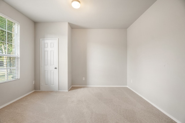 spare room with light colored carpet