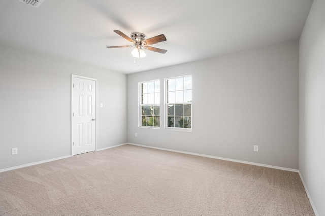 carpeted empty room featuring ceiling fan