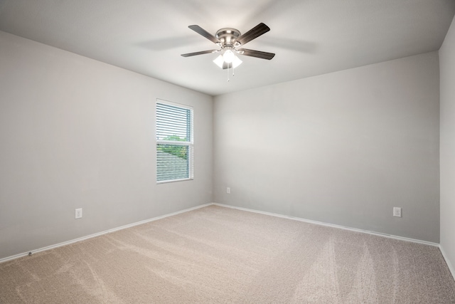 empty room featuring ceiling fan and carpet