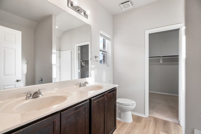 bathroom with hardwood / wood-style flooring, vanity, and toilet